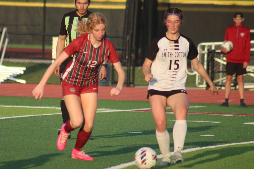 Warrensburg sophomore Reese Glover balances the ball against Smith-Cotton on Friday, April 11, at the Warrensburg Activities Complex.