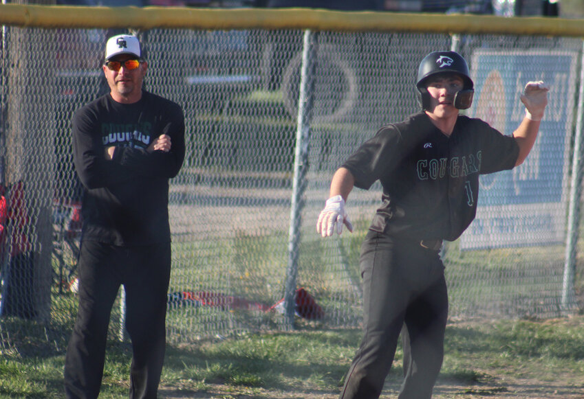 Crest Ridge head coach Michael Mullins watches as junior Carsen Hursh leads off from third base during a game against Kingsville Tuesday, April 15, at the Kingsville Ballpark.