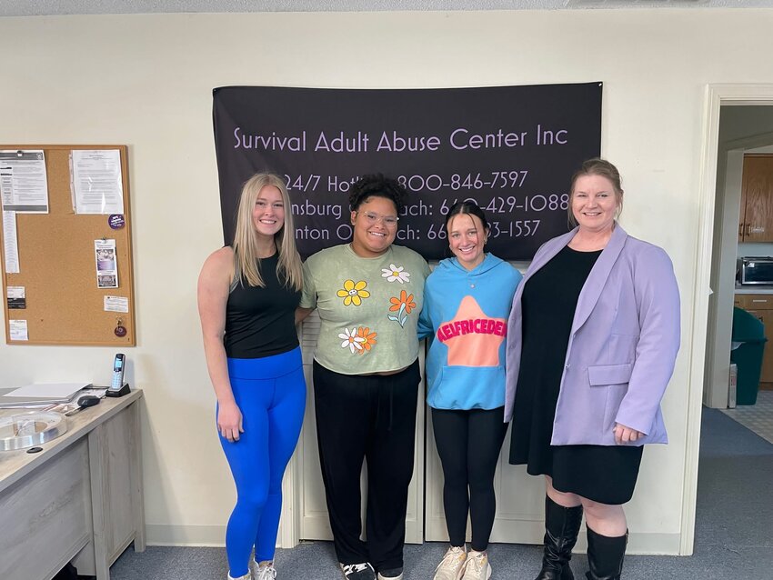 From left, Warrensburg High School student council students Maddie Meldrem, Mattie Derritt and Marissa Kennish pose for a photo with Survival House Executive Director Alisa White after presenting her with the $3,785 check raised by the student council.