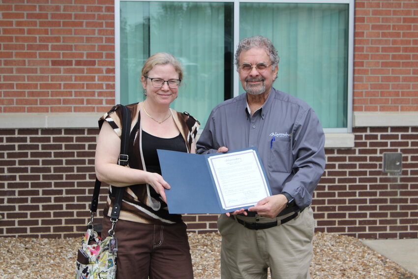 Warrensburg Mayor Pro-Tem Eddie Osborne, right, presents a proclamation to Warrensburg Energy &amp; Sustainability Task Force member Kathy Strickland, left, on Friday, April 25, at the city&rsquo;s Arbor Day Ceremony at the Warrensburg Community Center. Strickland received the proclamation due to the absence of Energy &amp; Sustainability Task Force Chair Suzy Latare.