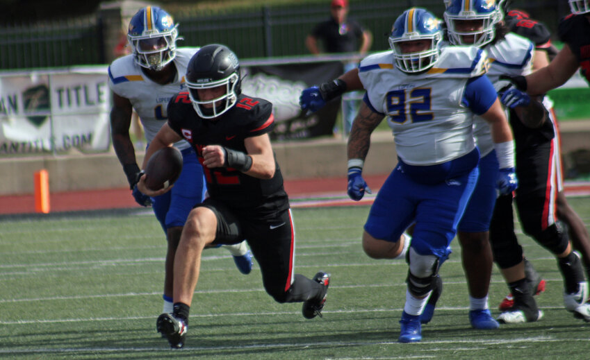 Central Missouri redshirt senior quarterback Zach Zebrowski runs past Nebraska-Kearney defenders on  Sept. 28, 2024, at Walton Stadium.
