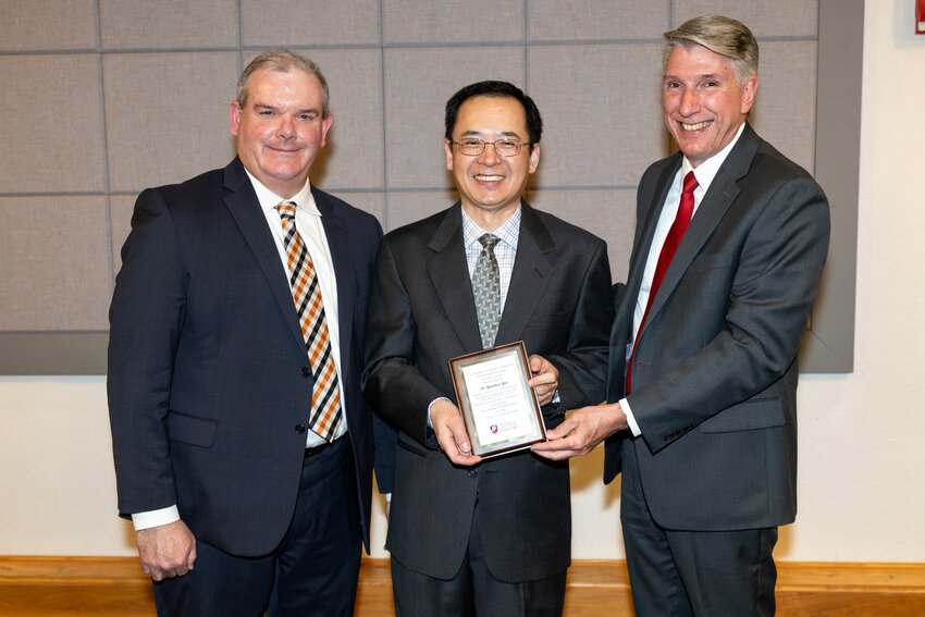 From left, Provost and Vice President for Academic Affairs Tim Crowley, Byler Award recipient Dr. Yuankun Yao and President Roger Best.