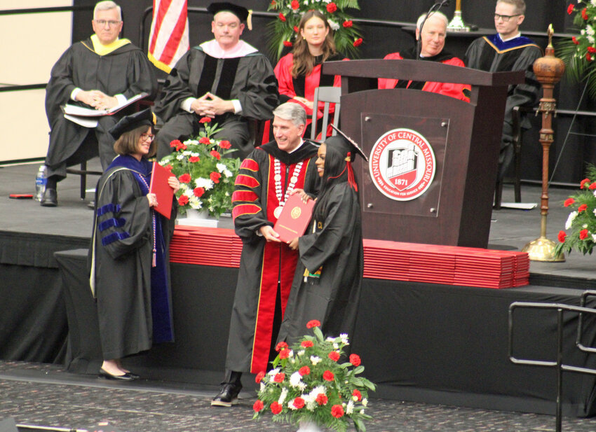 A candidate recieves her diploma from President Roger Best during the University of Central Missouri’s afternoon commencement Saturday, May 10, at the Jerry M. Hughes Athletics Center.