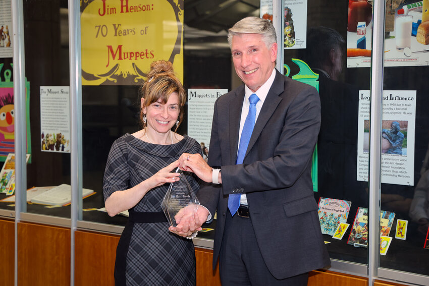 UCM President Roger Best presents the Kirkpatrick Excellence in Governance Award to Mara Woody.