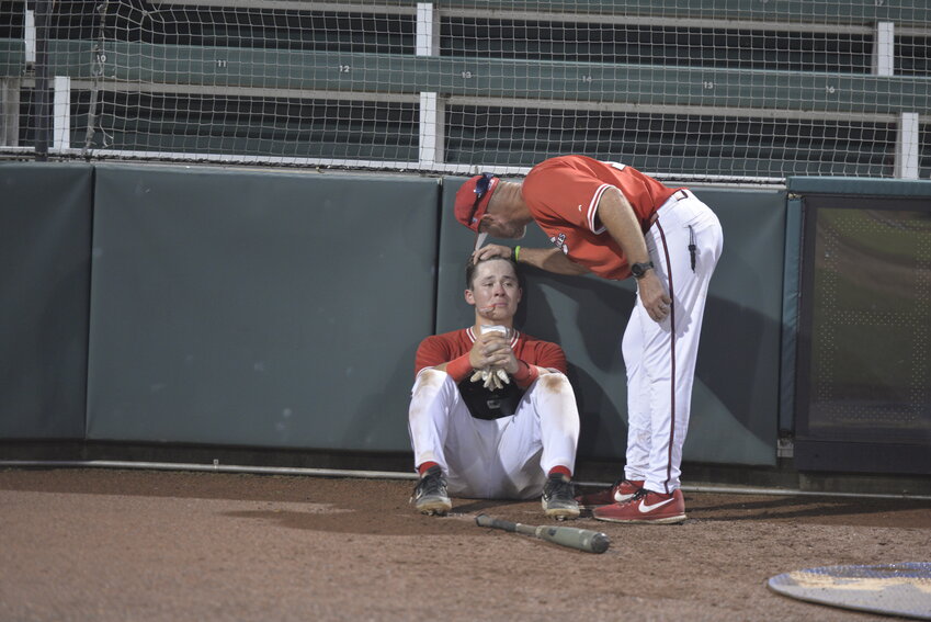 Kyle Crookes consoles dejected second baseman Grant Hollister after the final out of the NCAA Division II College World Series on Saturday, June 7, in Cary, North Carolina.