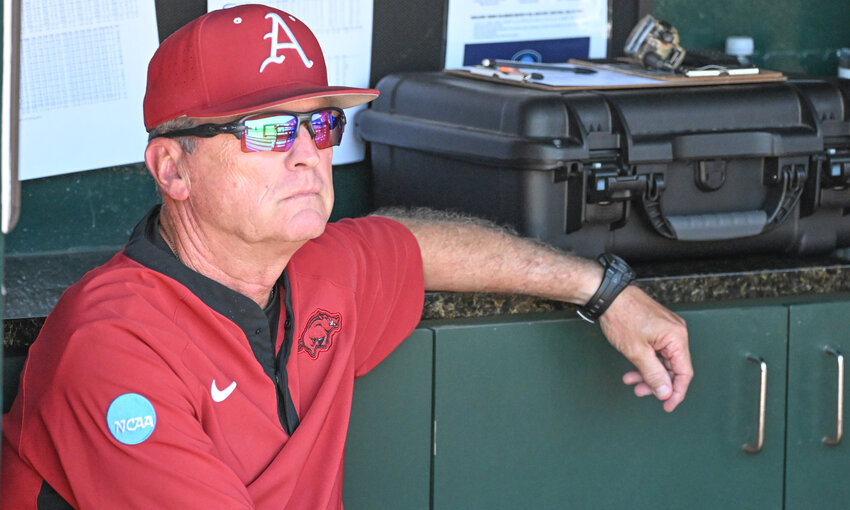 Arkansas head baseball coach Dave Van Horn relaxes in the dugout before their game against Tennessee on Sunday June 8, at Baum-Walker Stadium  in Fayetteville, Arkansas. Van Horn coached the University of Central Missouri to a national championship in 1994.