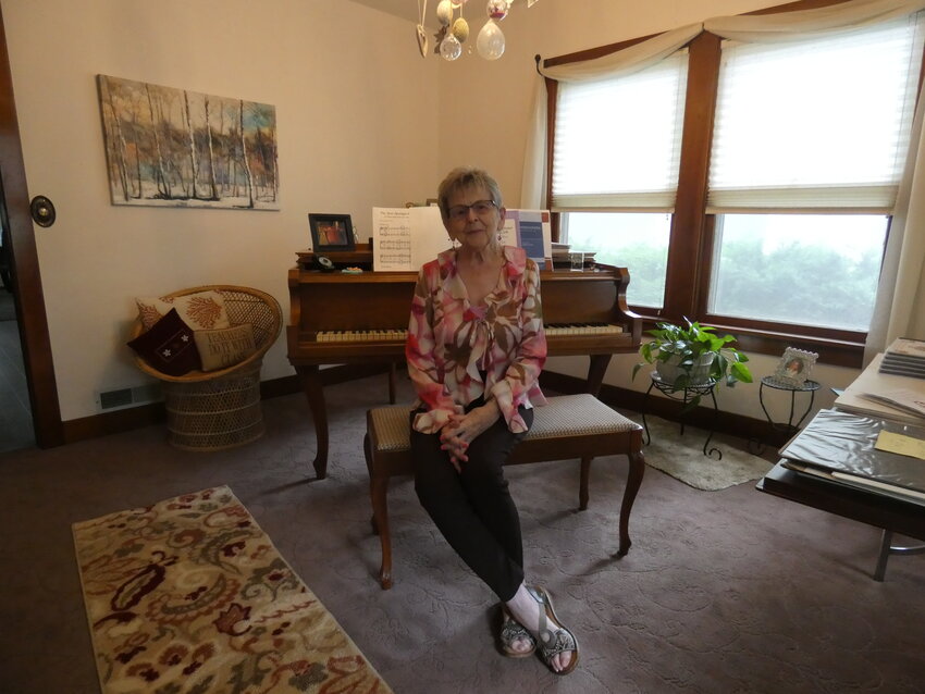 Cathi Truesdale sits at the piano, in her home, that she has used for her piano lessons for over 50 years. Truesdale takes pride in her contributions to the community and her passion for music.