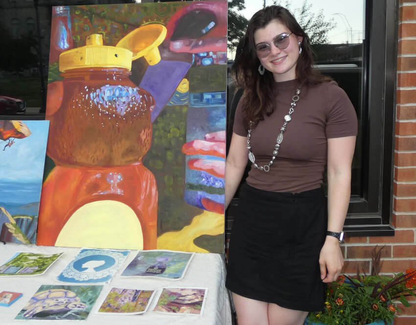 Madison Alexander stands next to her piece titled &ldquo;On the Fly&rdquo;  at her booth at Main Street Events Third Wednesday Art Walk on June 18, 2025. This piece is Alexander's favorite because of the large amount of dedication she put into it.