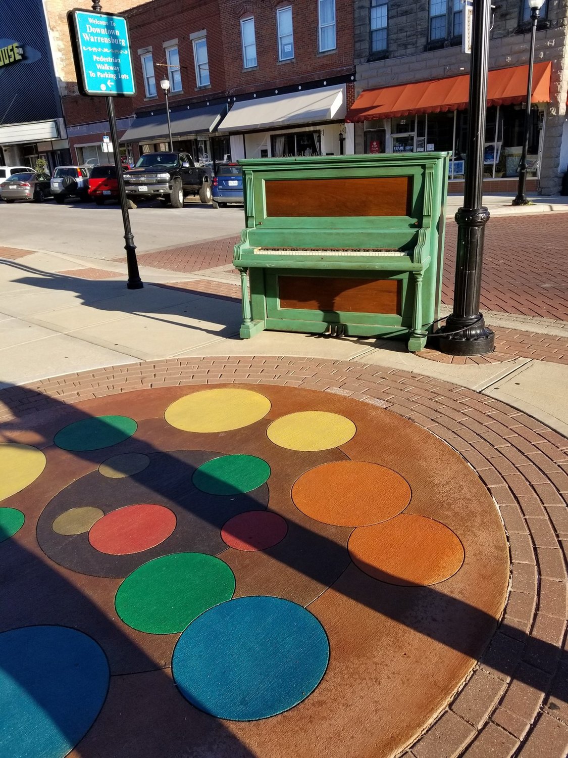 Two art installations, one movable and one set into the sidewalk, are displayed in the 100 block of West Pine Street. 