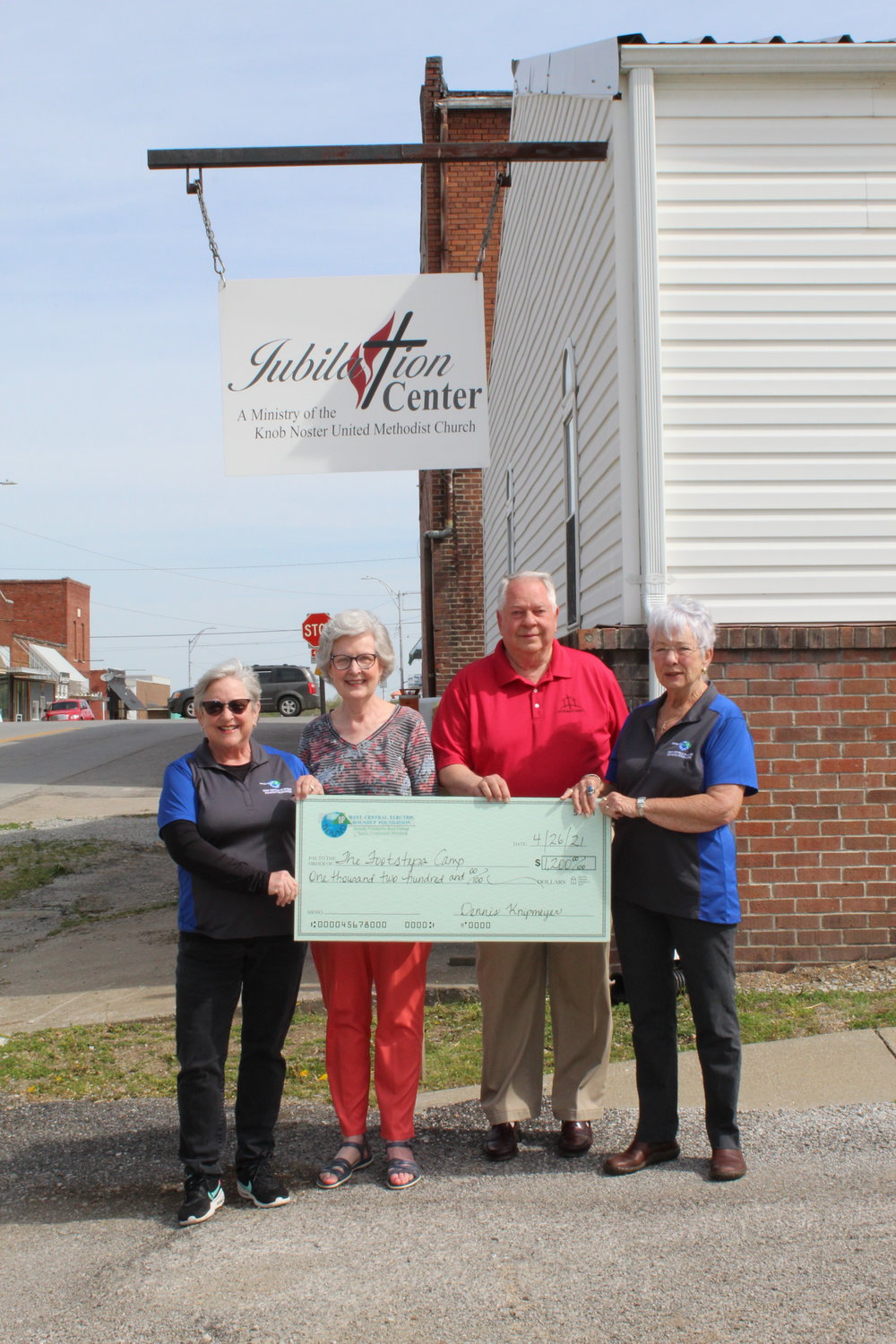 West Central Electric Cooperative Round Up members Sally Davidson (left) and Donna Matthews (right) present a check to Footsteps Camps Coordinator Carolyn Akins and Chairman Jerry Akins.