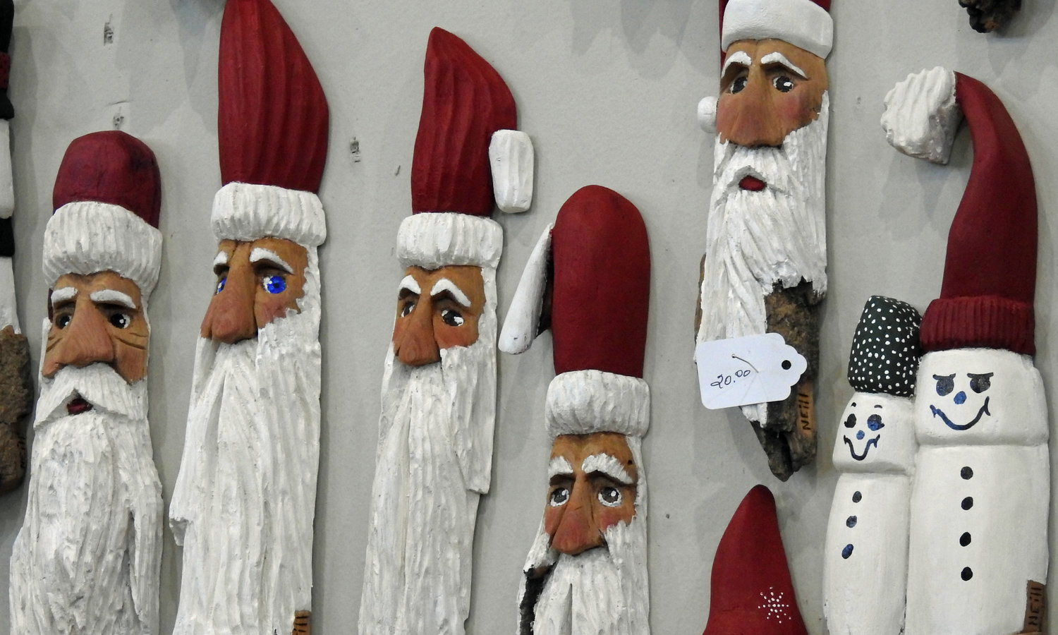 Cottonwood carvings by Charlie Neill hang on display at Holiday Arts and Crafts Show.