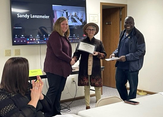 Melissa Gower is recognized for the Leaders Honor Roll. From left, Kim Hall, Gower, and Stephen Mukembo.