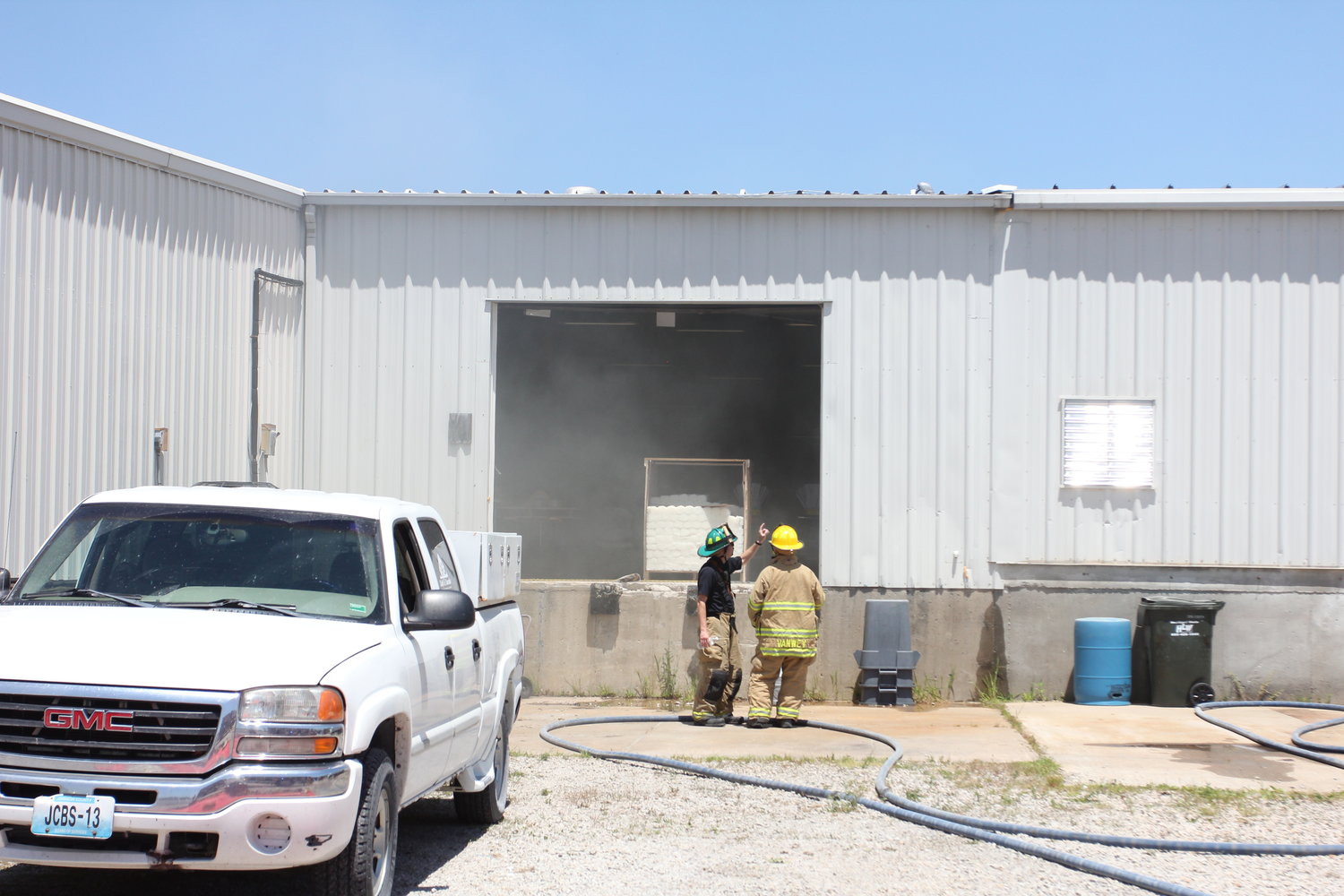 Firefighters work Wednesday, June 29, to ventilate the warehouse at RISE Community Services.