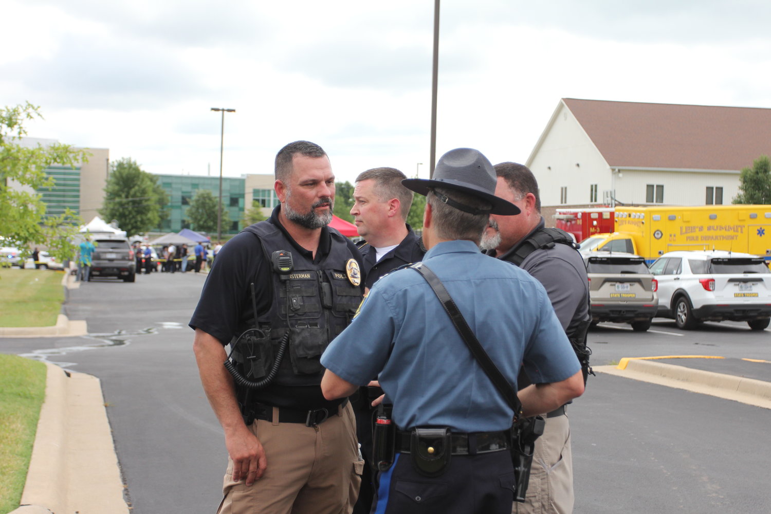 Warrensburg Police Department Interim Police Chief Andy Munsterman speaks with officers from other agencies Friday morning, July 8 after the all clear was given at what was an active scene at Western Missouri Medical Center. Responding agencies used The Park at Grover Park Baptist Church, across the street from WMMC, as a staging area.