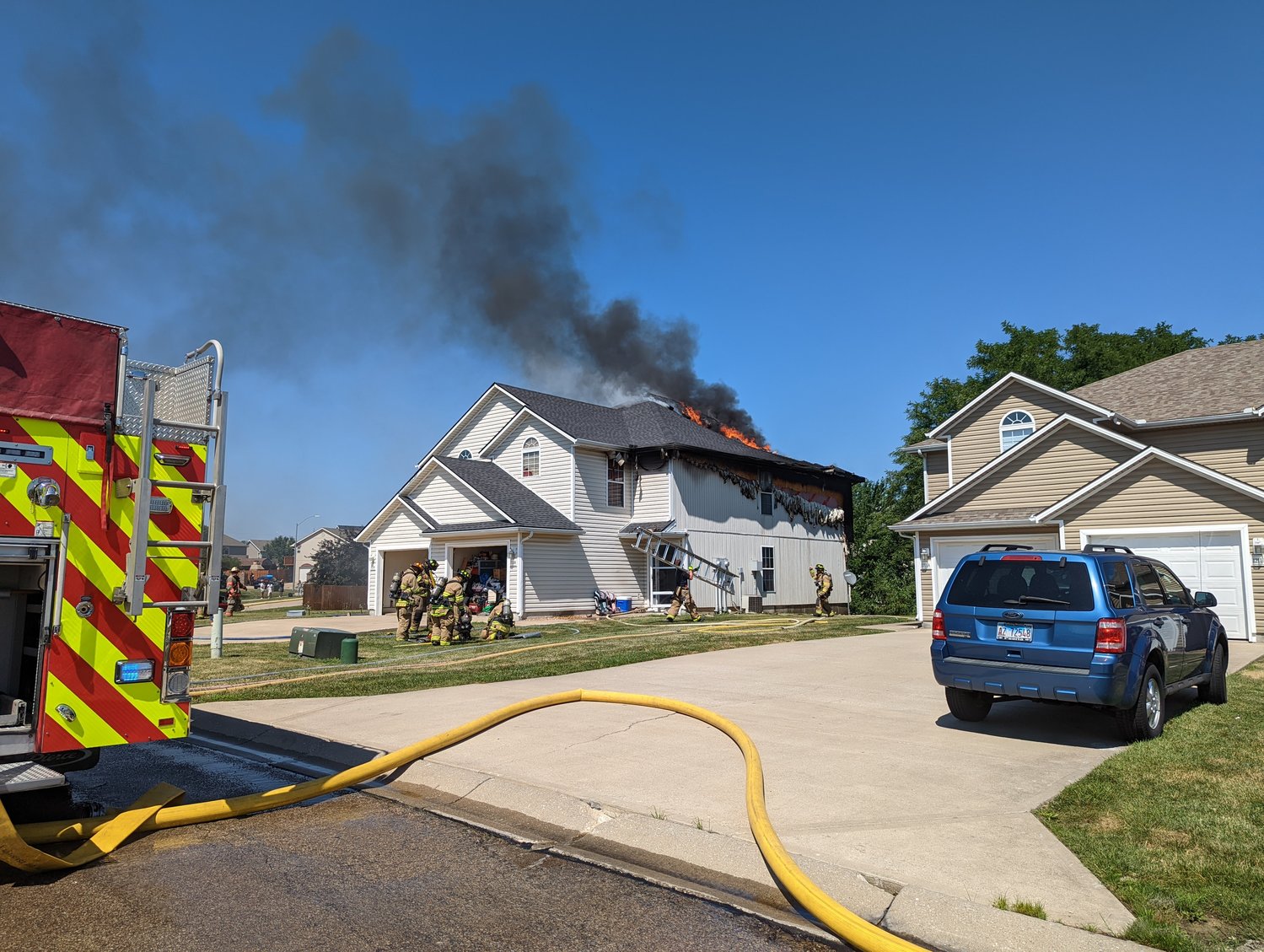 Firefighters from the Warrensburg Fire Department and the Johnson County Fire Protection District work to extinguish a structure fire Sunday, July 10, in the 1200 block of Pebblecreek Drive.