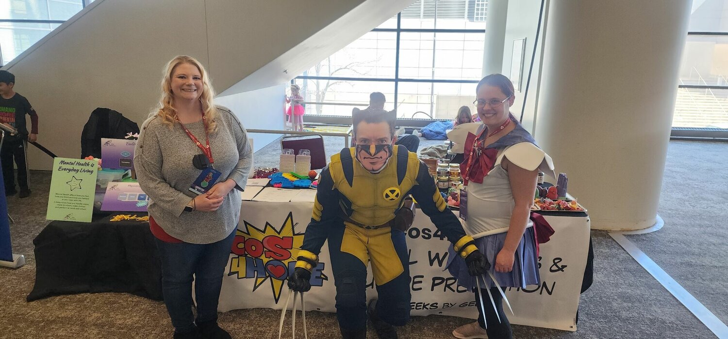 Cos4Hope co-founder April Roller-Morris, left, poses with a Wolverine cosplayer at the nonprofit's booth.
