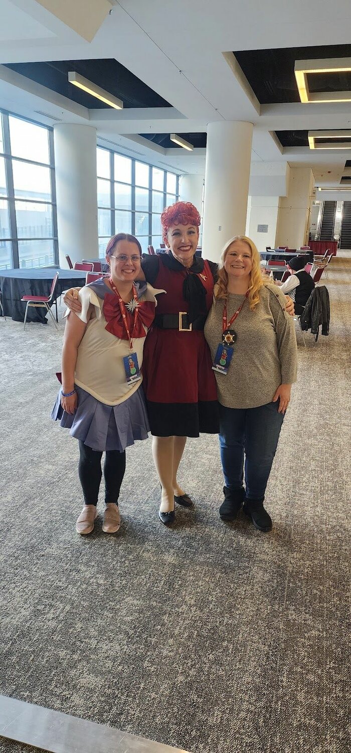 April Roller-Morris, right, poses with participants at a cosplay event. 