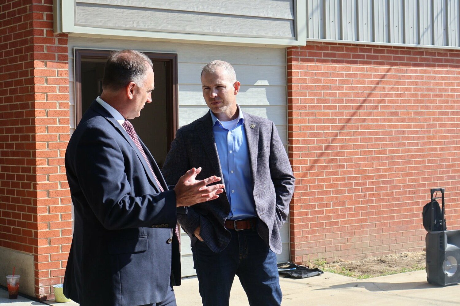 State Sen. Rick Brattin and Johnson County Associate Circuit Judge Brent Teichman speak outside of Recovery Lighthouse on Tuesday, Sept. 12. 