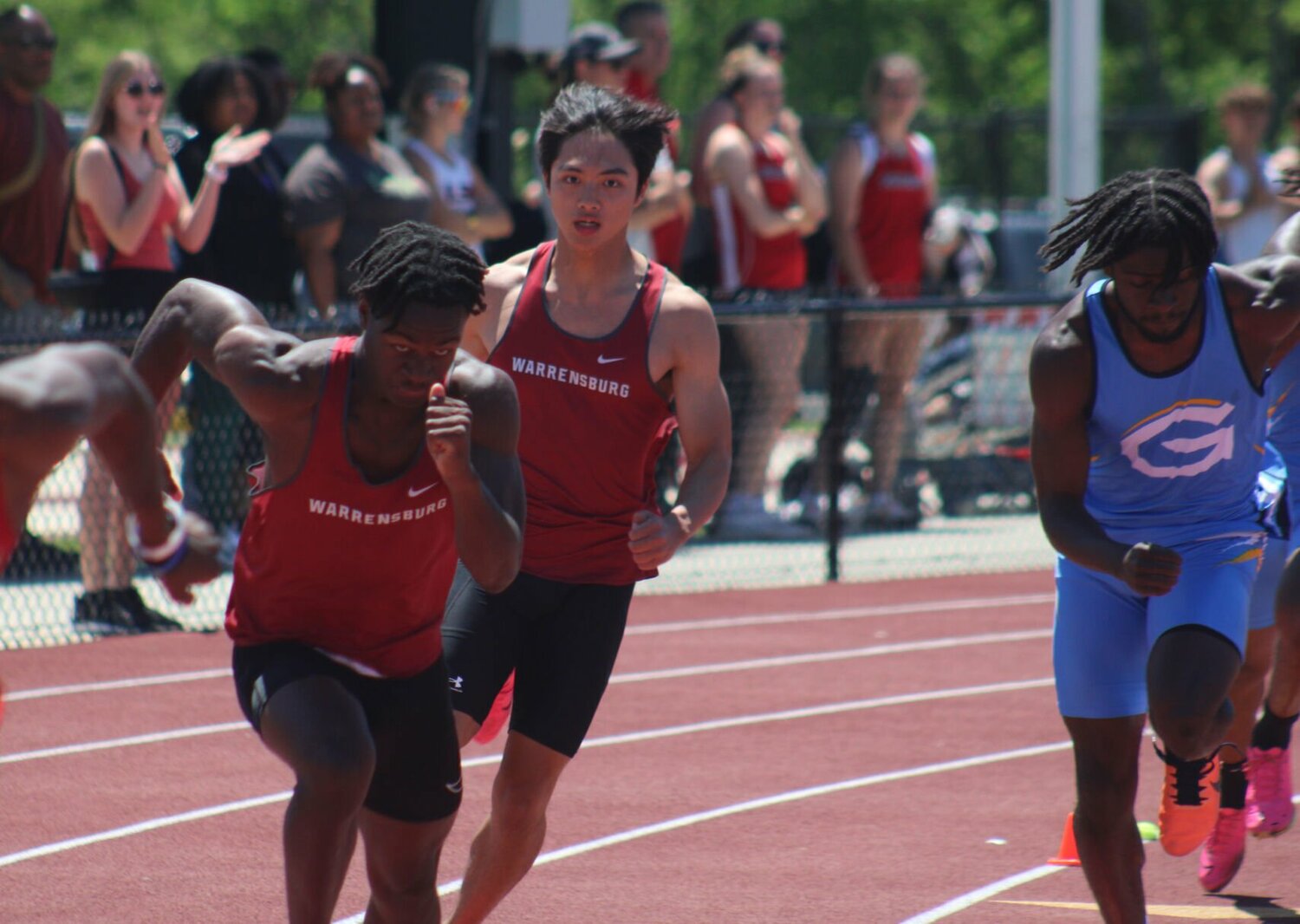 Warrensburg sophomore Seth Johnson takes off awaiting an exchange from junior Amir Ramos in the 4x100 meter relay during the MSSHAA Class 4 District 7 Championship on Satruday, May 11, at the Warresnburg Activities Complex.