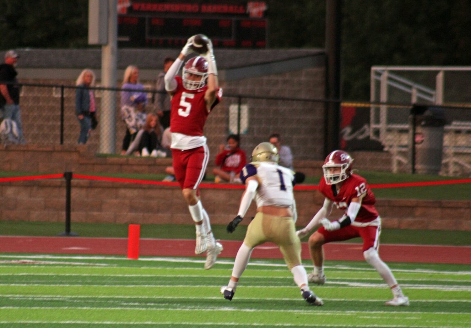 Warrensburg senior Ty Carman hauls in a catch against Pleasant Hill on Friday, Sept. 27, at the Warrensburg Activities Complex.