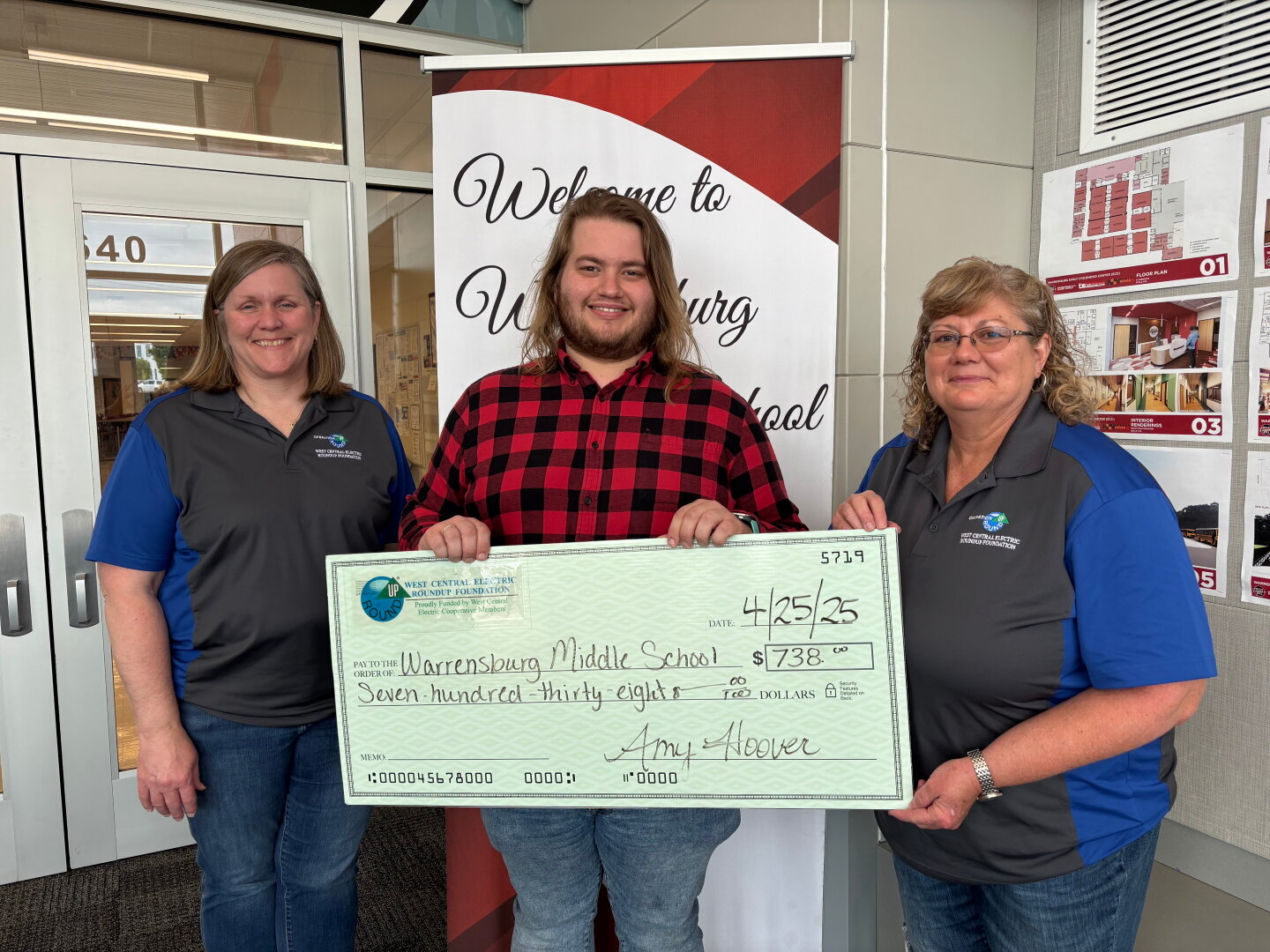 RoundUp Board members Kim Hall (left) and Patty Raker (right) present Warrensburg Middle School Choir Director Bob Cagle with a RoundUp grant.