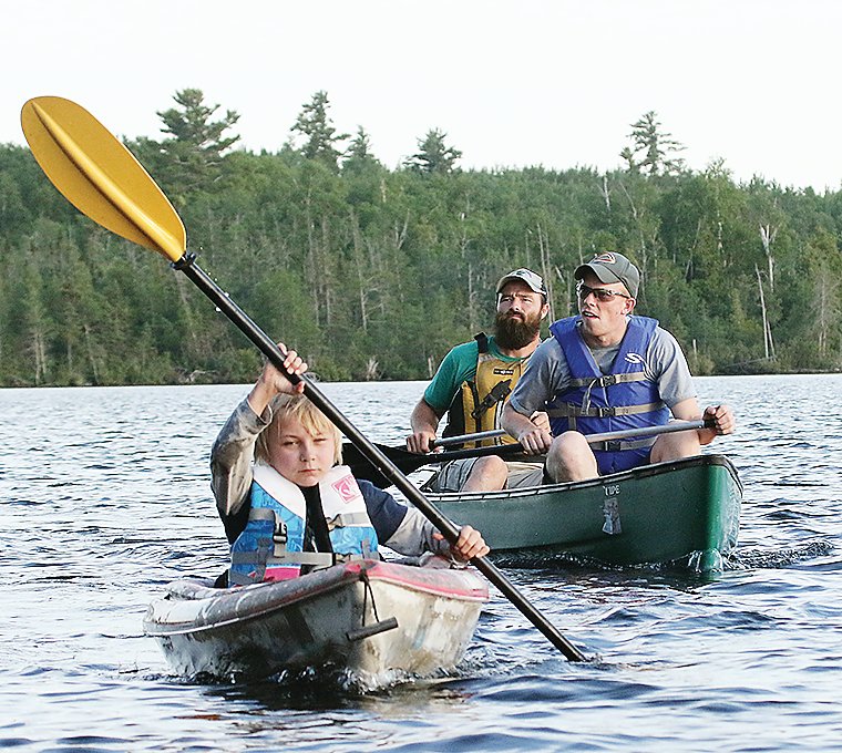 A determined young kayaker was part of the group. Bret Alexander looks on from the rear of the nearby canoe.