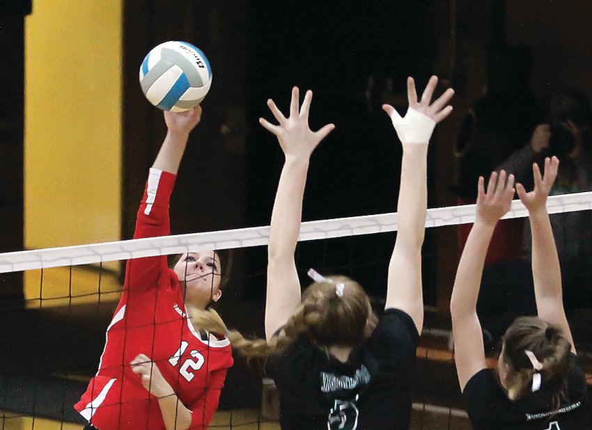 Ely junior Raven Sainio goes up high for a kill while the Nighthawks&rsquo; Hannah Reichensperger and a teammate attempt to block.  The   Nighthawks came closer than any team this season to defeating the Timberwolves.