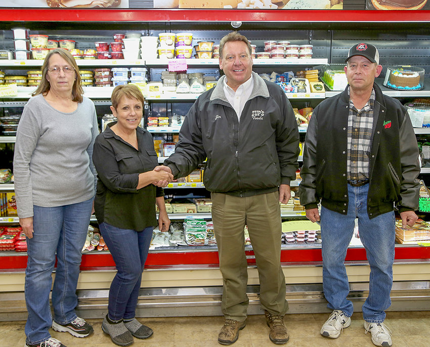 Shaking hands on an agreement Wednesday that will combine Ely&rsquo;s two grocery markets were Tracy Amitrano and Donna Richards of Ely Northland Market and Jim Zupanich Jr. and Bill Deyak of Zup&rsquo;s Food Markets.