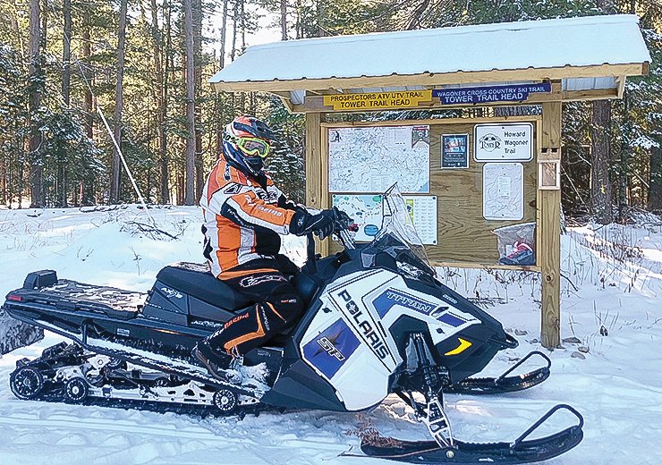Terry Wagoner is decked out as he gets ready to groom the Howard Wagoner ski trails, near Tower, with the trail club&rsquo;s new utility-grade snowmobile.