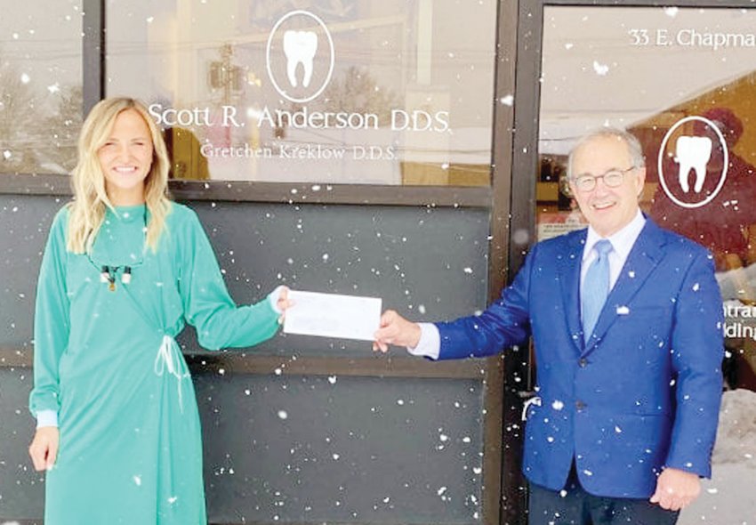 Dr. Michael Zakula of MDF presents Ely dentist Dr. Gretchen Kreklow with the first installment of the IRRR loan forgiveness grant.