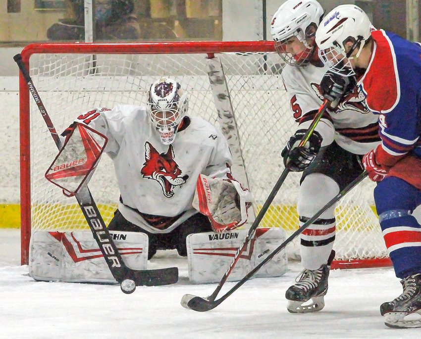 Ely goalie Ben Cavalier blocks a shot during recent action against the Moose Lake Area Rebels.  The   Rebels peppered Cavalier with 29 shots on goal.