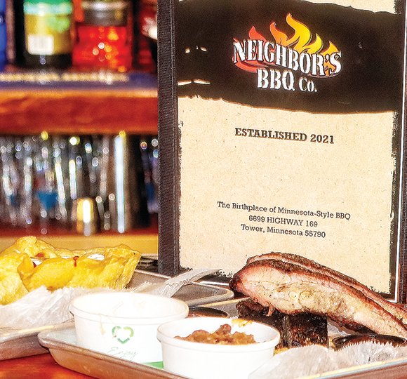 A half-slab dinner of Minnesota-style barbecue at Neighbor's BBQ, complemented by beans, cole slaw, and tortilla bowl chili.
