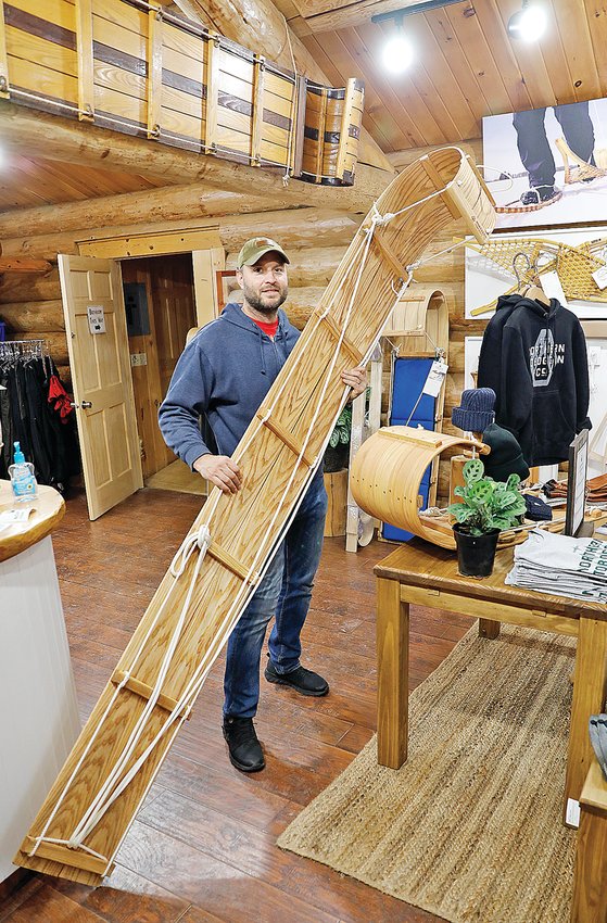 Jackson Harren, of Wintergreen Northern Wear, displays one of the products of the Northern Tobbogan Co. retail shop his family recently opened in downtown Ely.