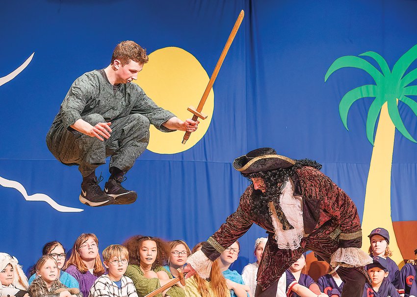 Steven Sopoci as Peter Pan tests his ability to fly high to avoid Captain Hook's swinging sword in the North Woods/Prairie Fire Children's Theater production of &quot;Peter Pan.&quot;