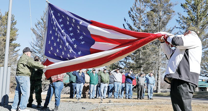 Ely area veterans gathered to pay respects to former board members of  Veterans on the Lake during the   recent raising of a Holiday Flag at the   facility on Fall Lake.