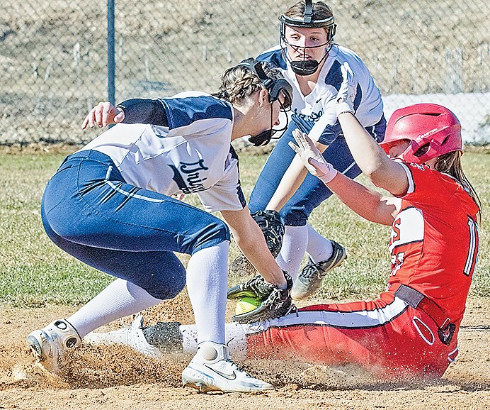 As teammate Karah Scofield backs up the play, the Grizzlies&rsquo; Skyler Yernatich tags out a stealing Ely baserunner.