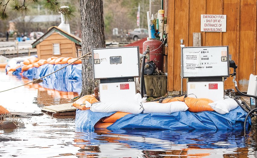 A wall of tarps and sandbags protects outbuildings and gas pumps at Voyagaire Lodge from Crane Lake&rsquo;s rising waters   on Saturday.