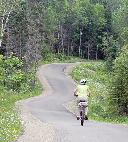 A lone cyclist pedals down a section of the Mesabi Trail.