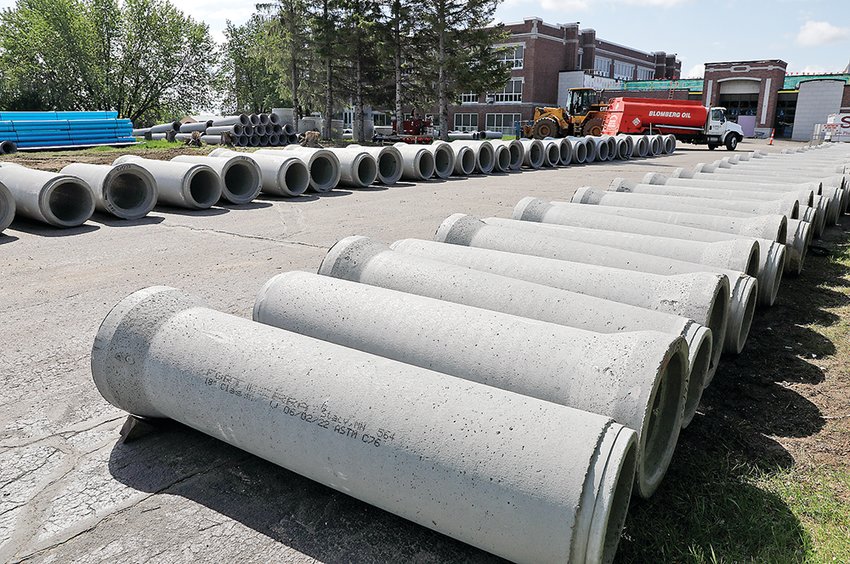 Water main and sewer pipes were lined up in the front yard of the Ely school campus this week.