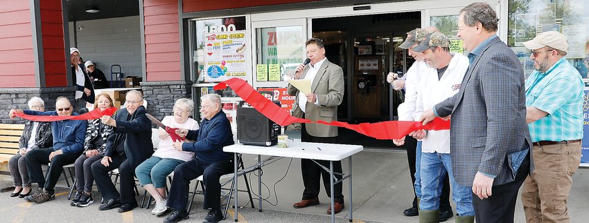 Jim Zupancich (center), with help from the large Zupancich family, cut the ribbon to signify the grand opening of the new store.