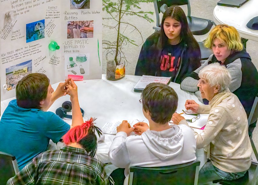 A group of Vermilion Country School students discuss their project on plastic pollution with evaluator Patricia Helmberger, of Tower.