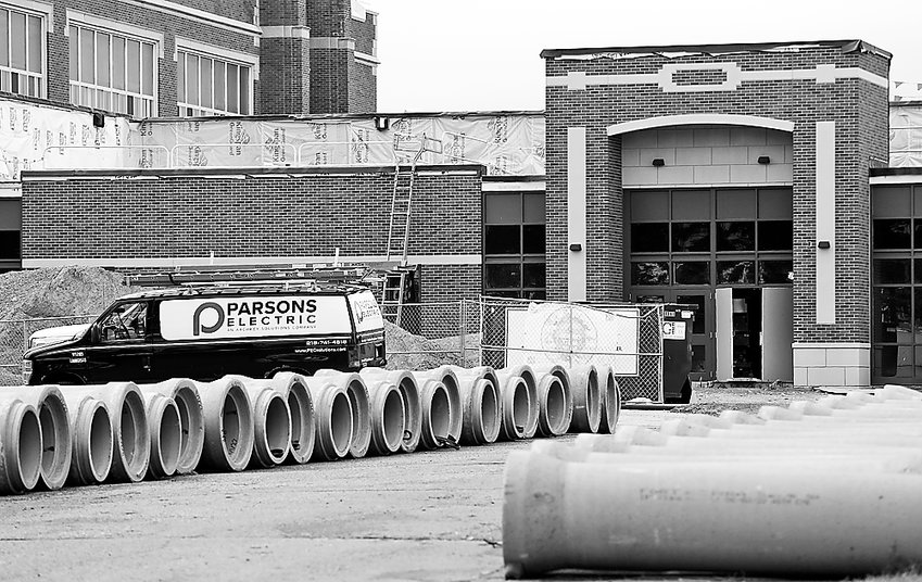 Cast concrete storm sewer pipes sit outside the new front entrance this week at the Ely school renovation project.