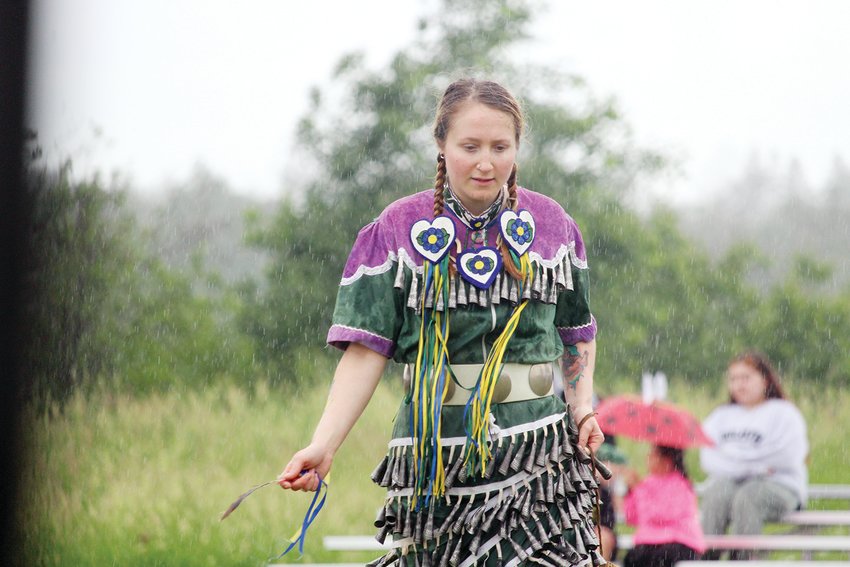 Ann Gawboy dances in the rain at the Lake Vermilion Traditional Pow Wow last weekend.