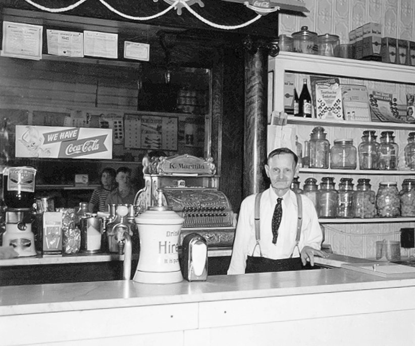 &quot;Konst&rdquo; Marttila   behind the counter of his confectionary and variety store in 1945. The shop was a popular place in Tower when it sold candy, milk shakes, comic books, and other delights.