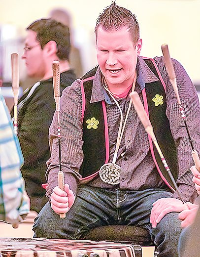 Chaz Wagner sings and plays the drum at a Nett Lake pow wow in March.