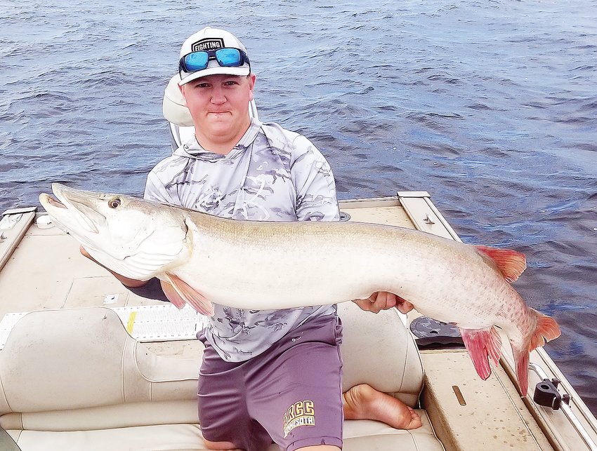 Brrett Vetterkind, of Somerset, Wis. hoists a   51-1/2 inch musky he caught late last week on Lake Vermilion.