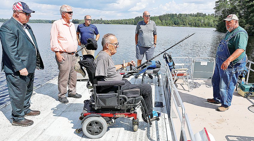 Disabled military veteran Lonn Cunningham gets ready to board a   pontoon boat for a Fall Lake fishing outing at Veterans on the Lake Resort.