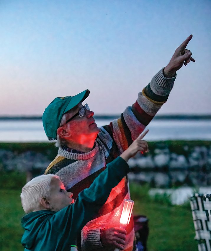 Well-known amateur astronomer &ldquo;Astro Bob&rdquo; and a young night sky enthusiast point out an early-appearing star as dusk was descending at the Voyageurs Star Party on Saturday.