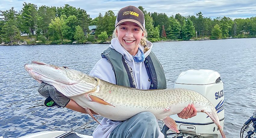 Elli Borovsky   displays the 50-inch muskie, caught on Lake Vermilion, that vaulted her and teammate Carter Graff to the high school state tourney   championship.