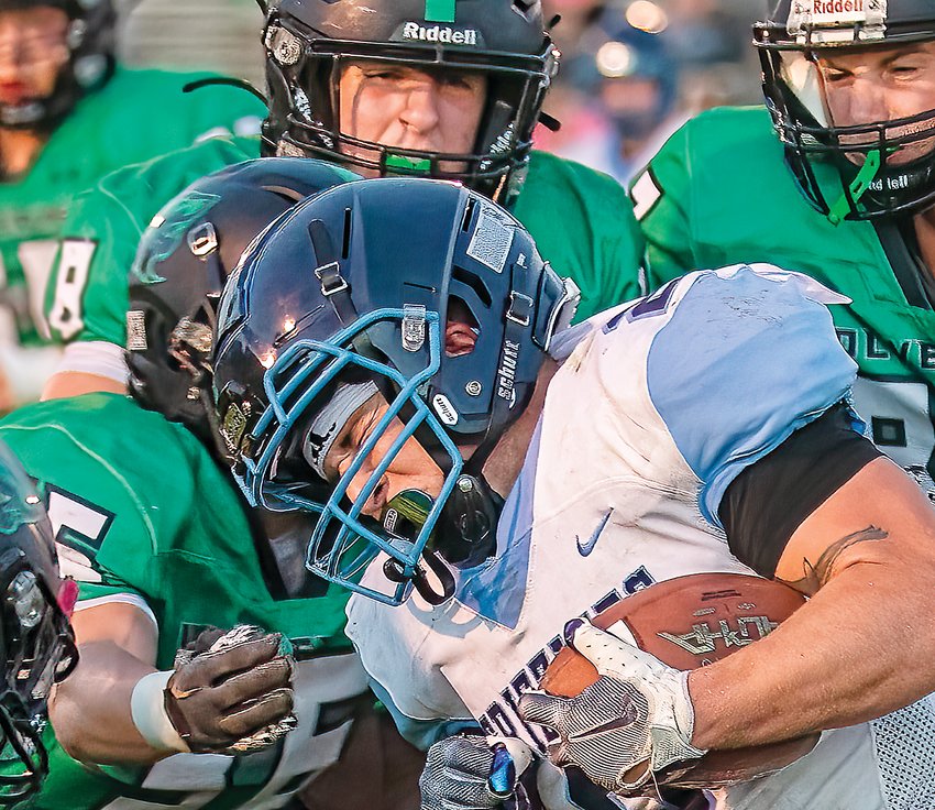 The   Grizzlies&rsquo; Jared   Chiabotti puts his head down as he tries to plow through a sea of green Rock Ridge   defenders.